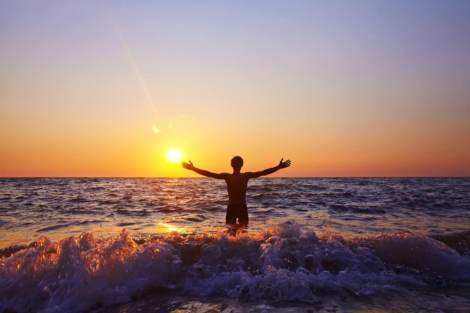 Mand bader i solnedgangen